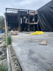 outside of a theatre destroyed by a hurricane